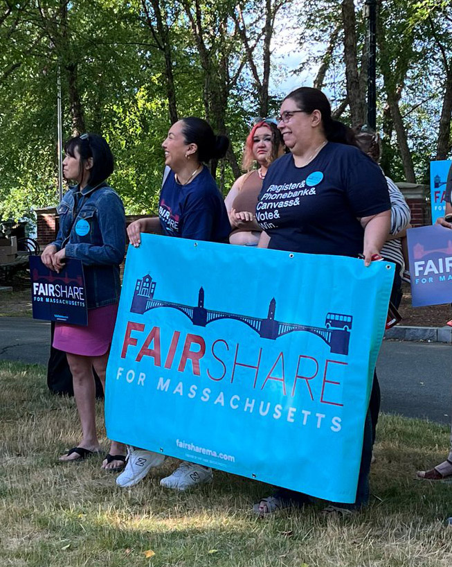 Zayda holding a banner for the Fair Share amendment in Lincoln Commons.